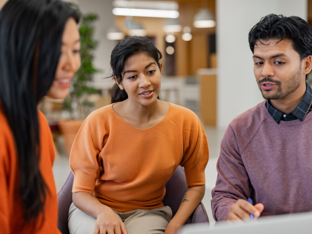 Team discussion highlighting charisma and confident communication in a professional setting