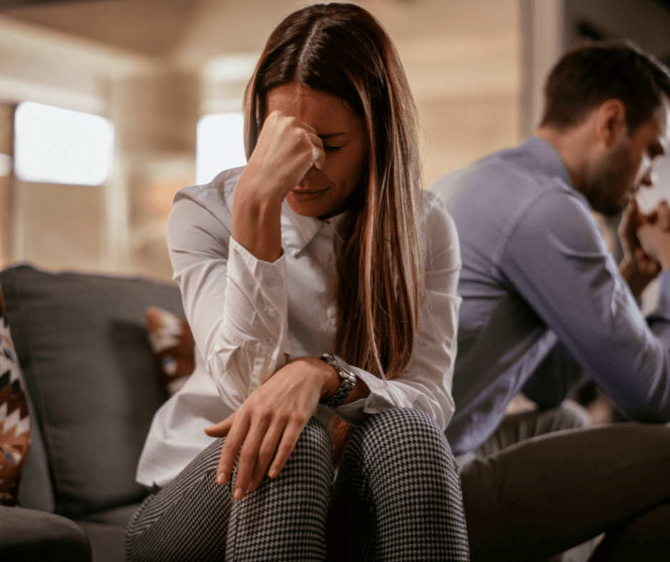 Sad woman crying while her partner ignores her — emotional neglect in a narcissistic relationship