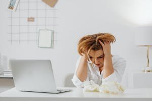 xhausted woman struggling with stress and anxiety management at work