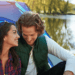 A couple smiling and communicating near a lake, illustrating how to improve your relationship through better communication and emotional connection.