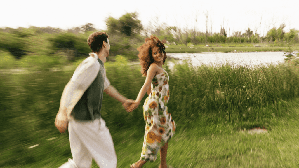 Couple running hand in hand through a field, symbolizing how to improve your relationship through emotional connection and communication.