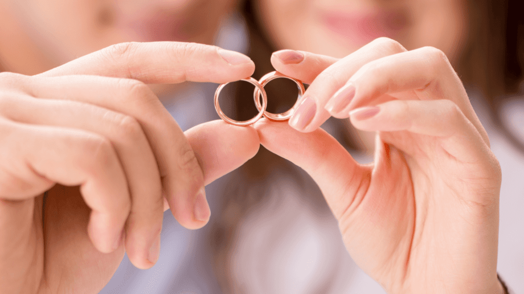 Couple holding wedding rings together symbolizing unity, love, and a healthy marriage that lasts.