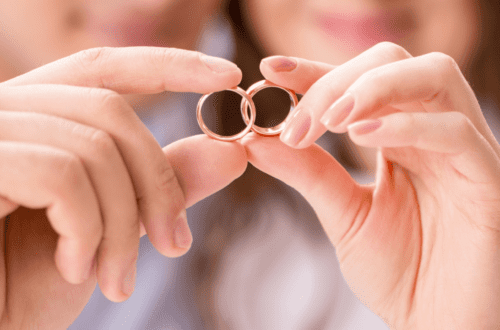 Couple holding wedding rings together symbolizing unity, love, and a healthy marriage that lasts.