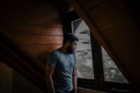 person sitting alone with quiet sadness showing the weight of recognizing signs of an unhealthy relationship
