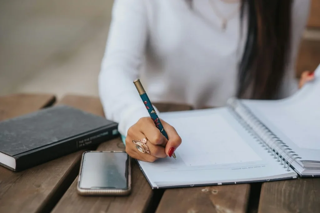 person journaling to identify where boundaries are being crossed