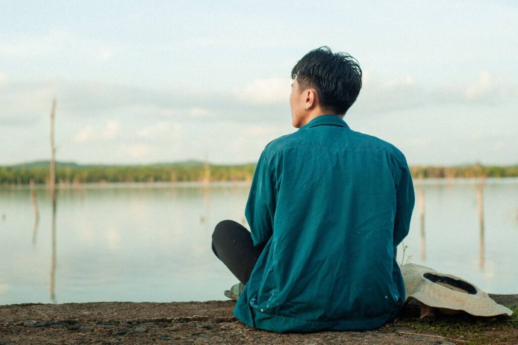 person sitting peacefully relieved after learning how to set boundaries and finally saying no
