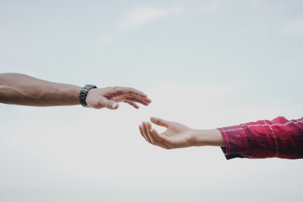 person reaching out hand showing the first honest move in how to fix a relationship