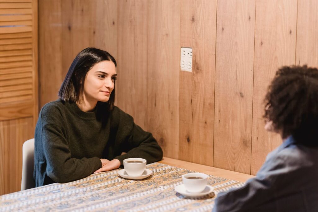 two people having an honest conversation, practicing how to stop being a people pleaser